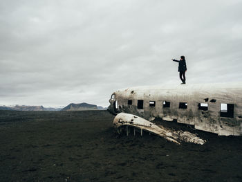 Man on shore against sky