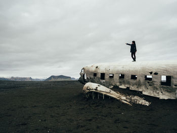 Man standing on airplane wreck