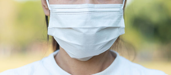Midsection of woman wearing mask outdoors