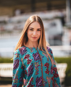 Portrait of smiling young woman standing outdoors