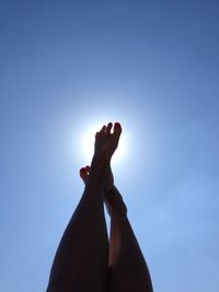 Woman feet against blue sky