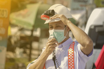 Close-up of man wearing mask talking on microphone