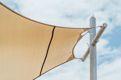 Low angle view of cross against sky