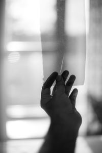 Close-up of hand holding window