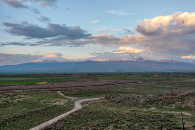 Scenic view of field against sky during sunset