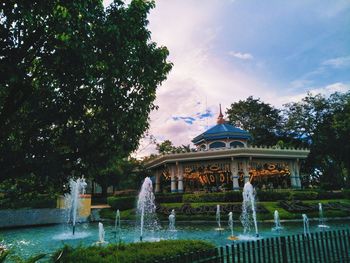 Fountain in park against sky