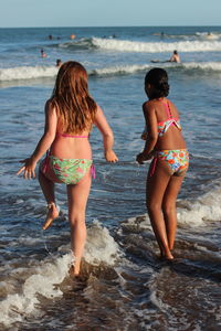 Rear view of girls on beach