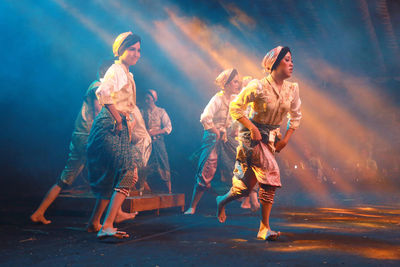 Group of people dancing at night