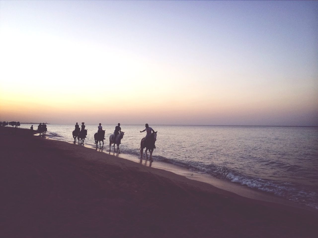 sea, sunset, horizon over water, water, beach, silhouette, copy space, clear sky, scenics, tranquil scene, men, tranquility, orange color, shore, leisure activity, beauty in nature, lifestyles, nature, walking