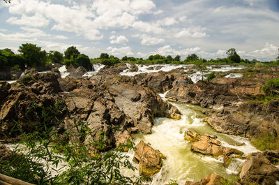 Scenic view of rocks on land against sky