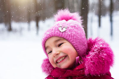 Portrait of smiling young woman in warm clothes