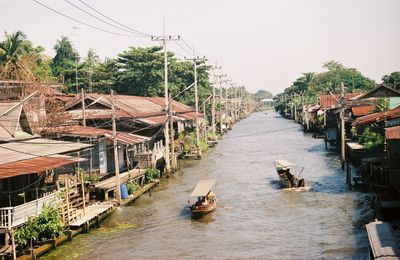 Boats in river against sky