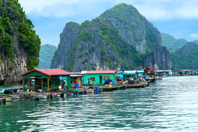 Scenic view of river and mountains against sky