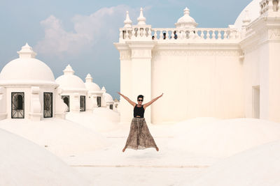 Full length of a woman with church in the background