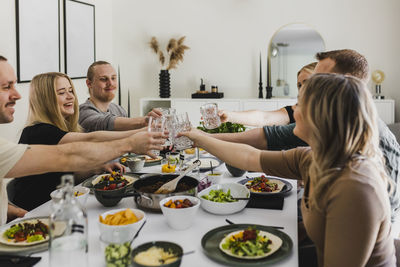 Group of friends raising toast during mexican feast