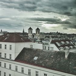 Buildings against cloudy sky