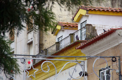 An old building mansard with two gable fronted roof dormers and a balcony