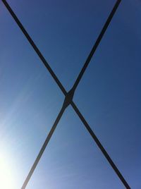 Low angle view of power lines against blue sky