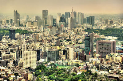 High angle view of modern buildings in city against sky