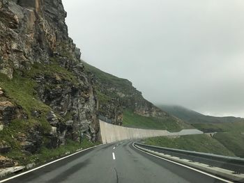 Road amidst mountains against sky