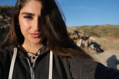 Portrait of beautiful woman against sky