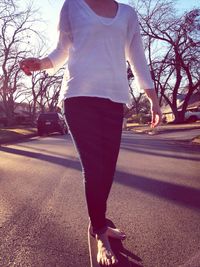 Rear view of woman walking on road