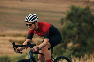 Man riding bicycle on field