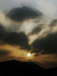 Scenic view of dramatic sky over silhouette landscape