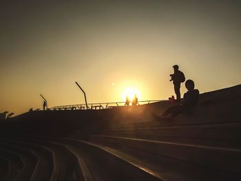 Silhouette of people at sunset