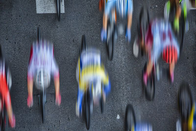 Blurred motion of men riding bicycles