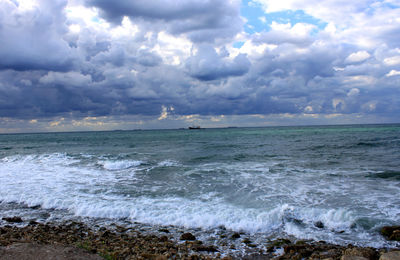 Scenic view of sea against storm clouds