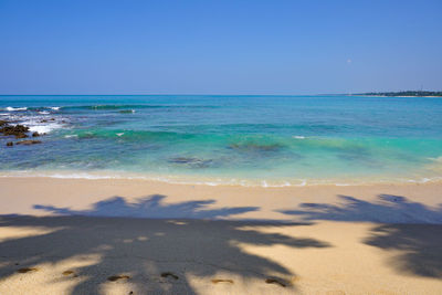 Scenic view of sea against clear blue sky