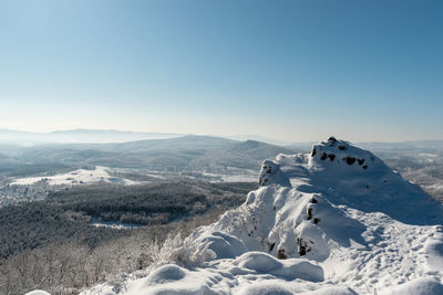 Scenic view of snowcapped mountains against clear sky