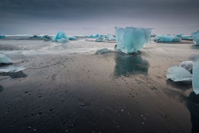 Scenic view of frozen sea against sky