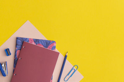 School stationery on yellow background. top view with copy space. flat lay. 