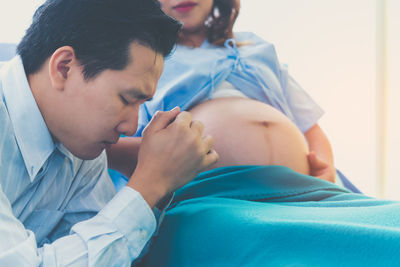 Midsection of man lying on bed