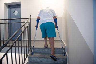 Rear view of woman walking on staircase