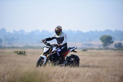 Person riding motorcycle on field