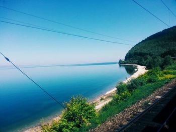 Scenic view of sea against clear blue sky