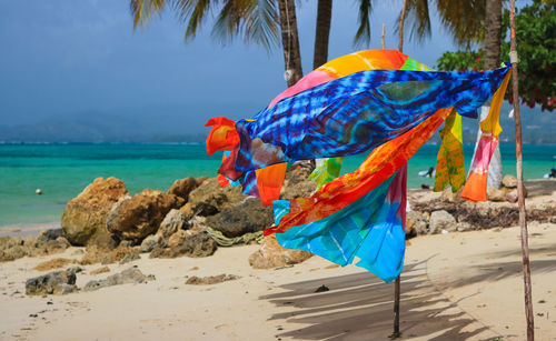 Close-up of multi colored umbrella on beach