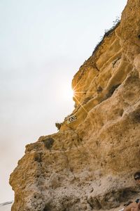 Low angle view of rock formations against sky