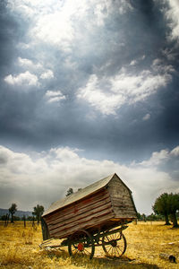 Barn on field against sky