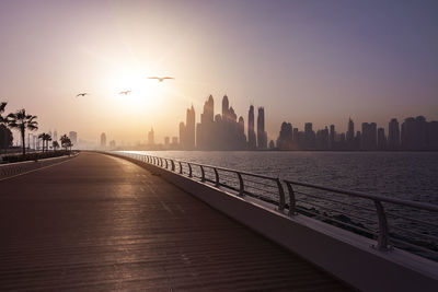 View of buildings in city at sunset