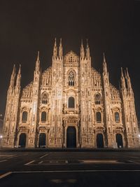 Low angle view of illuminated building against sky at night