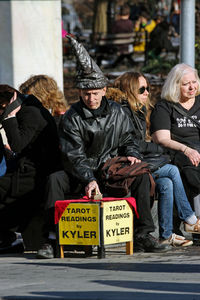 Group of people sitting in city