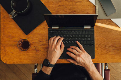 High angle view of man using laptop on table