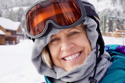 Portrait of smiling woman wearing ski goggles