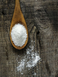 High angle view of wooden spoon with salt