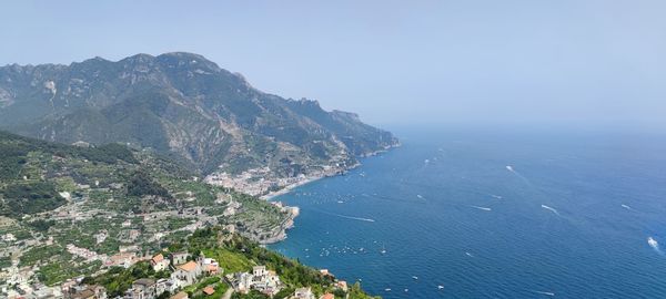 High angle view of townscape by sea against sky