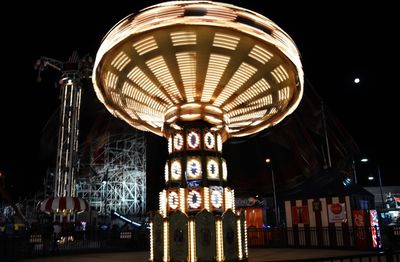 Low angle view of illuminated lights at night